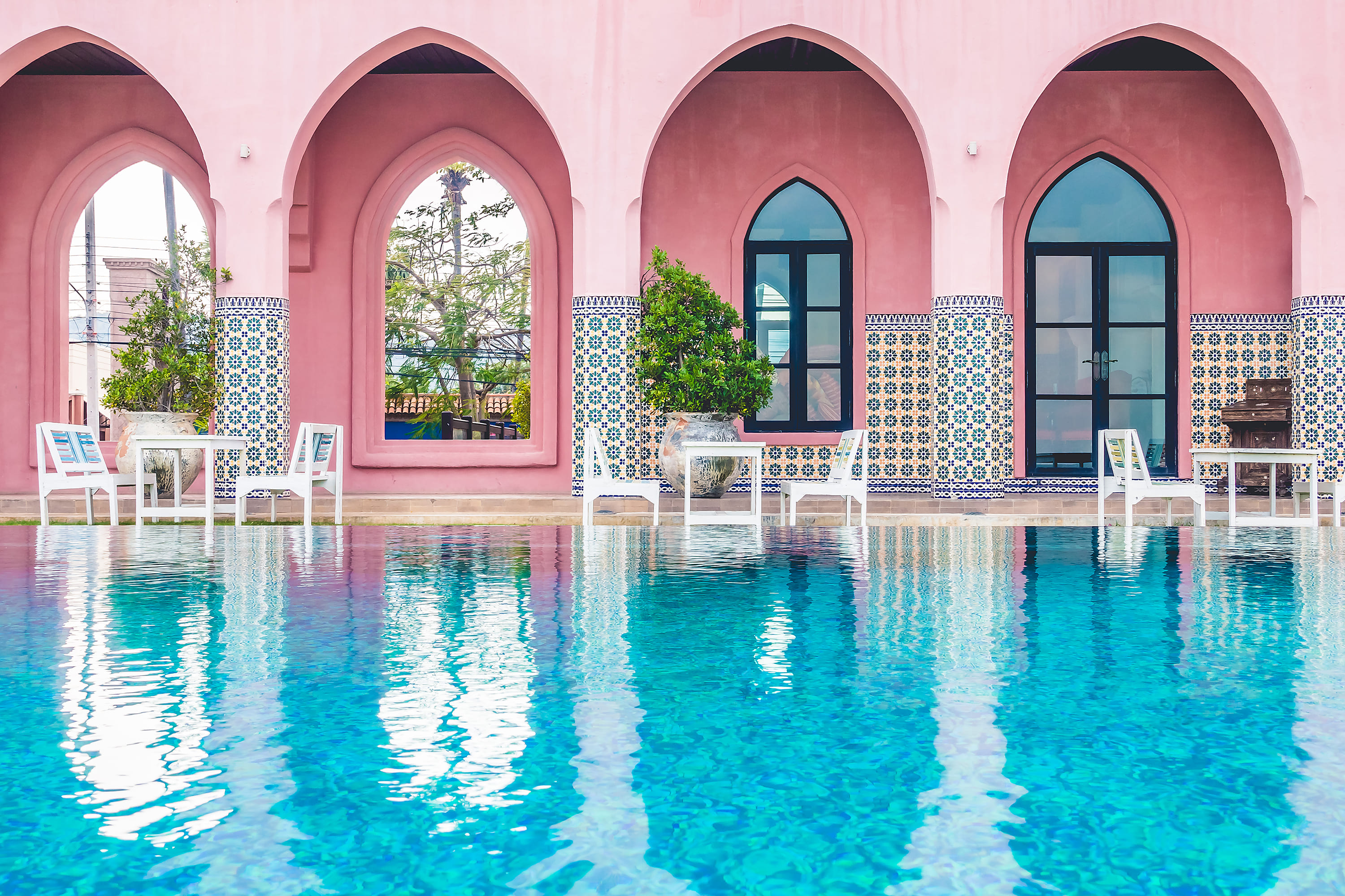 Riad pool with Moroccan arches — riad vs villa